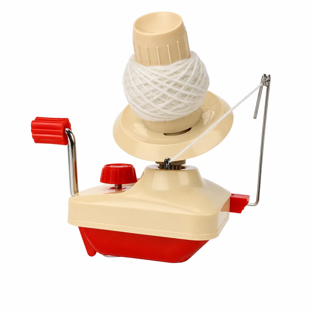 The cream and red ball winder with a part-wound centre-pull ball on its spindle and the strand running through the metal yarn guide