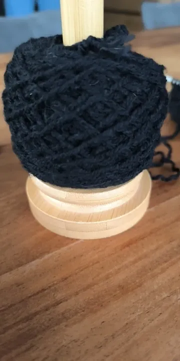 Dark blue yarn ball finished on the ball winder spindle, photo from a verified buyer